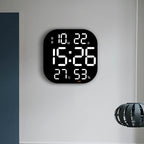 Cavira LED acrylic smart wall clock with digital display, thermometer, alarm, countdown, and night light in a modern living room setting