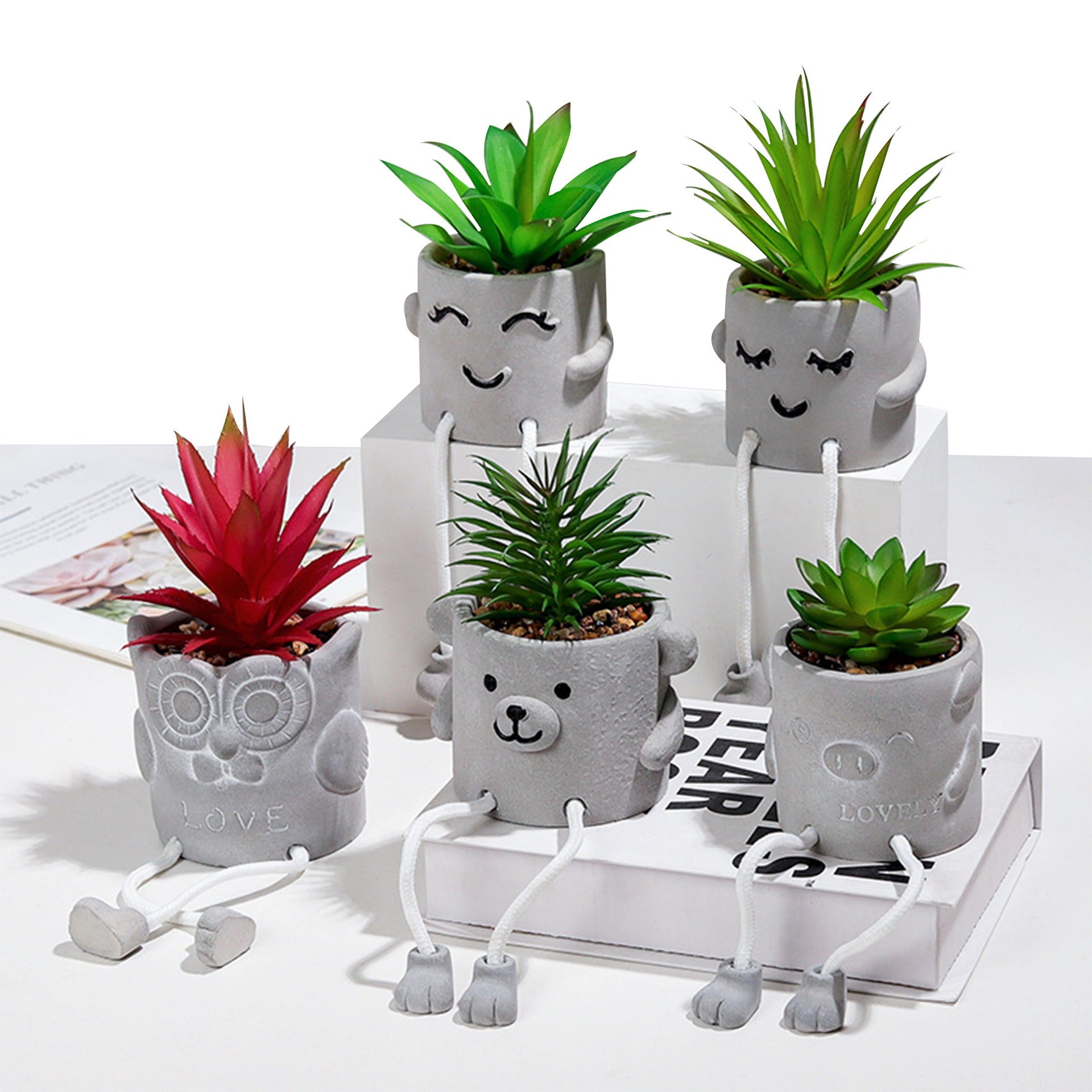 Cavira novelty hanging legs succulent pot with character face design, featuring dangling feet; cute desk or shelf décor in various styles.