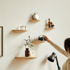 Wooden semicircle wall shelf by Cavira, floating half circle design for bedroom, living room, or home decor storage.