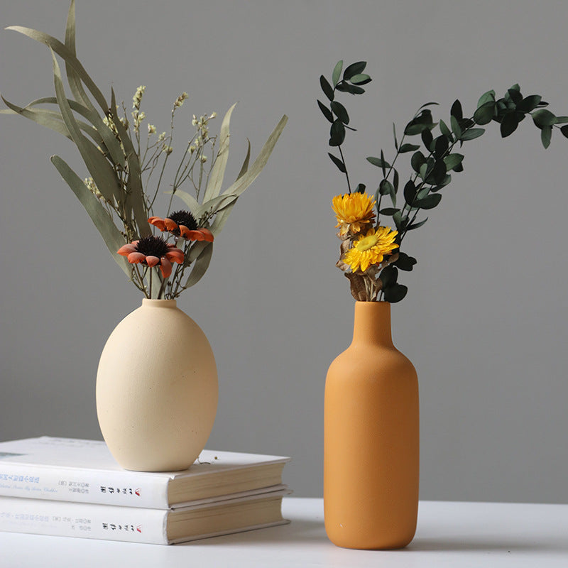 Set of four white porcelain ceramic vases by Cavira, modern minimalist design for floral arrangements and home decor.