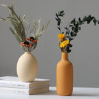 Set of four white porcelain ceramic vases by Cavira, modern minimalist design for floral arrangements and home decor.