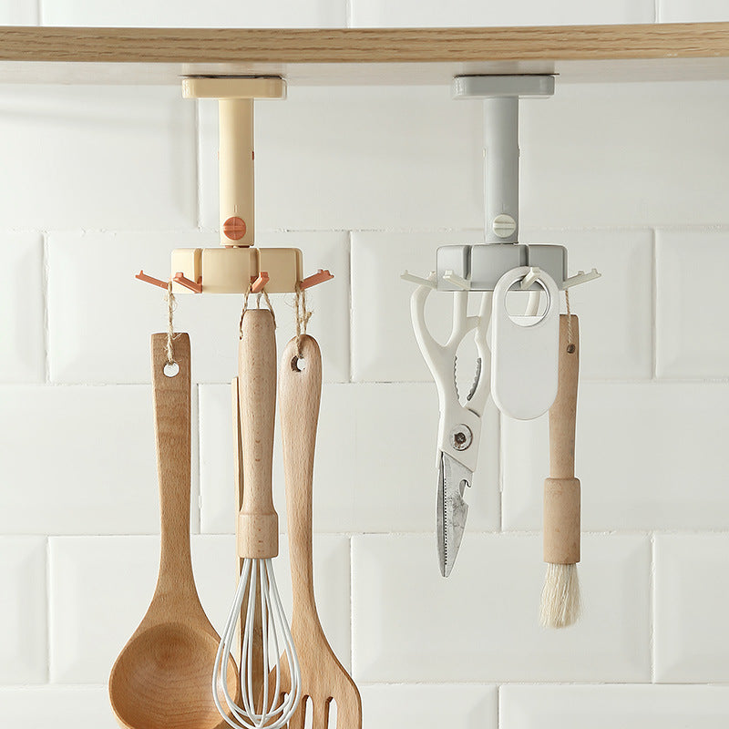 Cavira rotary multi-row adhesive wall hook in black, mounted on a kitchen wall for organizing utensils and accessories.