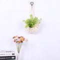 Handwoven boho cotton rope wall hanging net basket with woven flower design, ideal for home, bedroom, and living room decor.