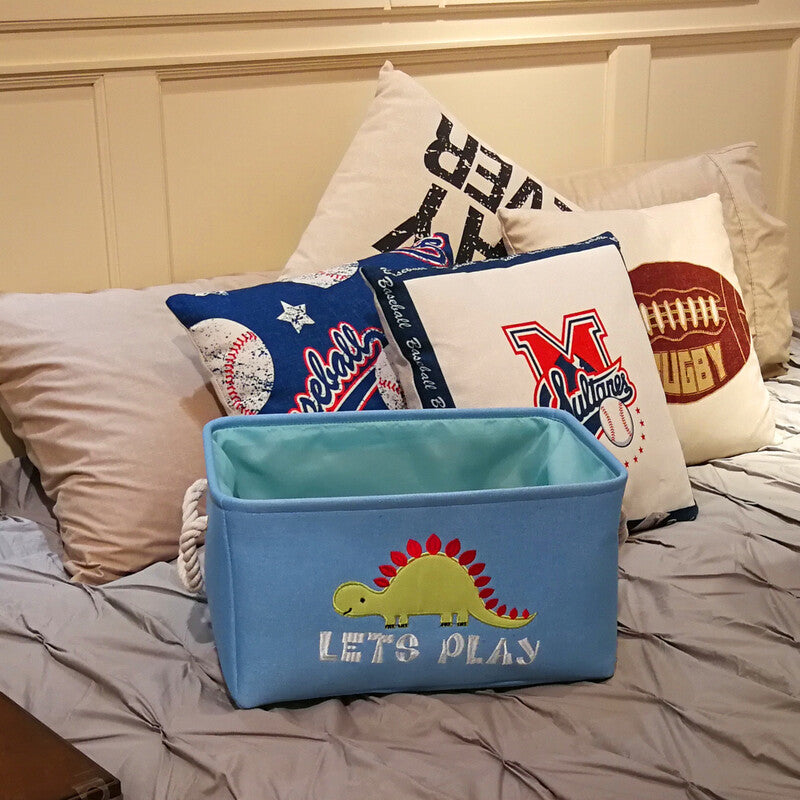 Canvas folding dinosaur storage basket by Cavira with embroidered cartoon dinosaur, ideal for kids' toys and stationery in nursery or bedroom