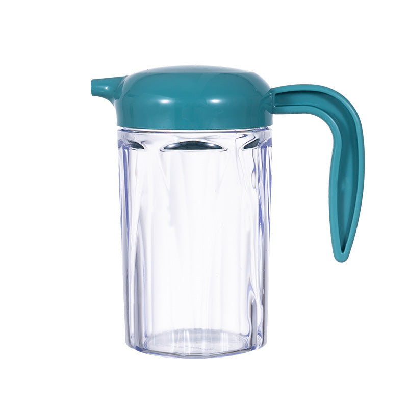 Transparent Cavira precision pour oil and condiment dispenser with eagle-beak spout, designed for drip-free, one-handed operation.