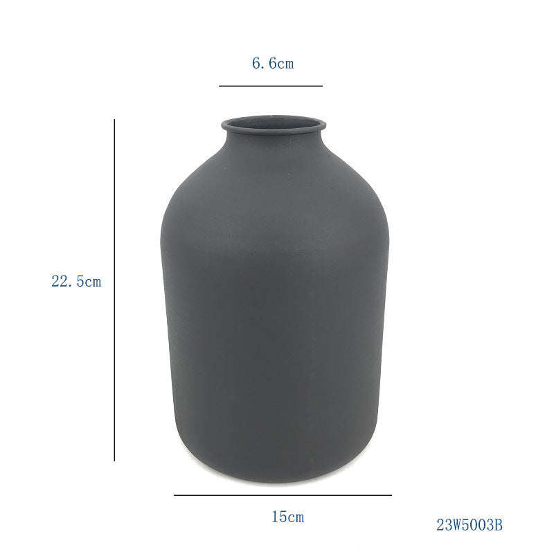 White matte metal vase with a unique sculptural shape for dried flowers, ideal for home or wedding décor, by Cavira.