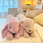 Oversized Cavira plush bear and rabbit cuddle pillows with long waists, perfect for bedroom or sofa decor and cozy gifting.