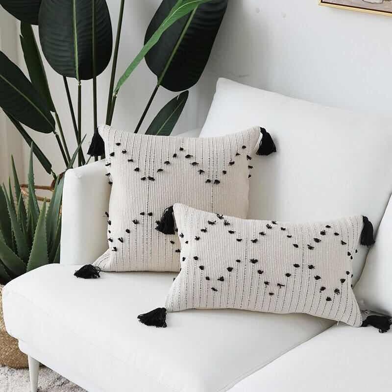 Hand embroidered bohemian throw pillow cover by Cavira, woven cotton cushion with minimalist design for sofa, bedroom, or living room.