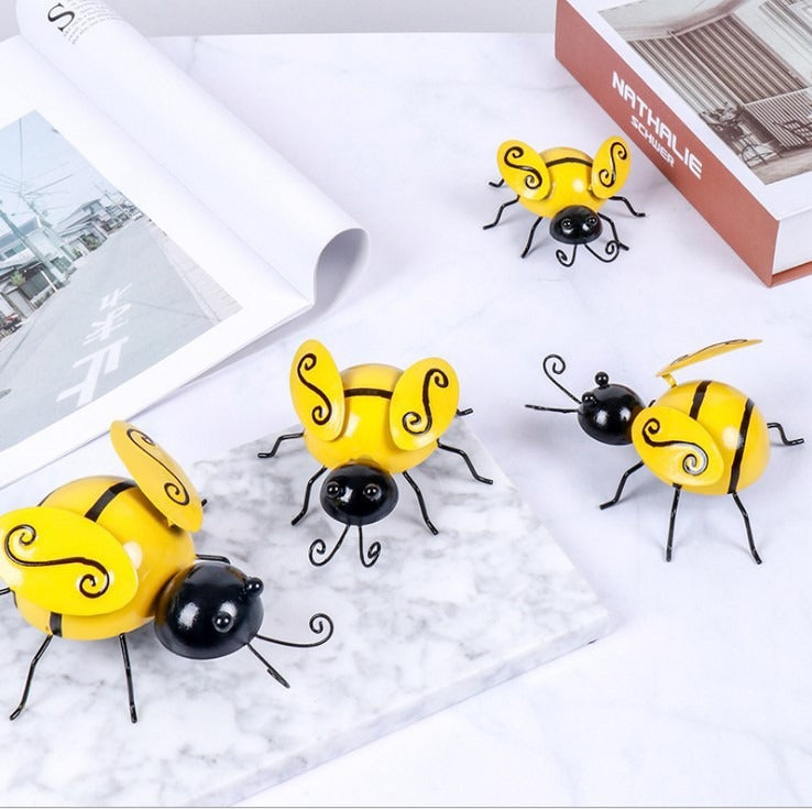 Set of four Cavira Iron Bee wall art sculptures, 3D metal animal wall hangings for home, garden, or rustic farmhouse decor.