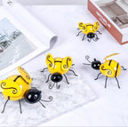 Set of four Cavira Iron Bee wall art sculptures, 3D metal animal wall hangings for home, garden, or rustic farmhouse decor.