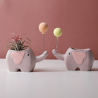 Cute ceramic succulent pot by Cavira featuring elephant, dinosaur, and flower designs, perfect for small plants on desks or shelves.