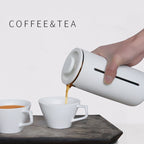 Portable Borosilicate glass French press with white and black frame for coffee and tea brewing at home, office, or travel.