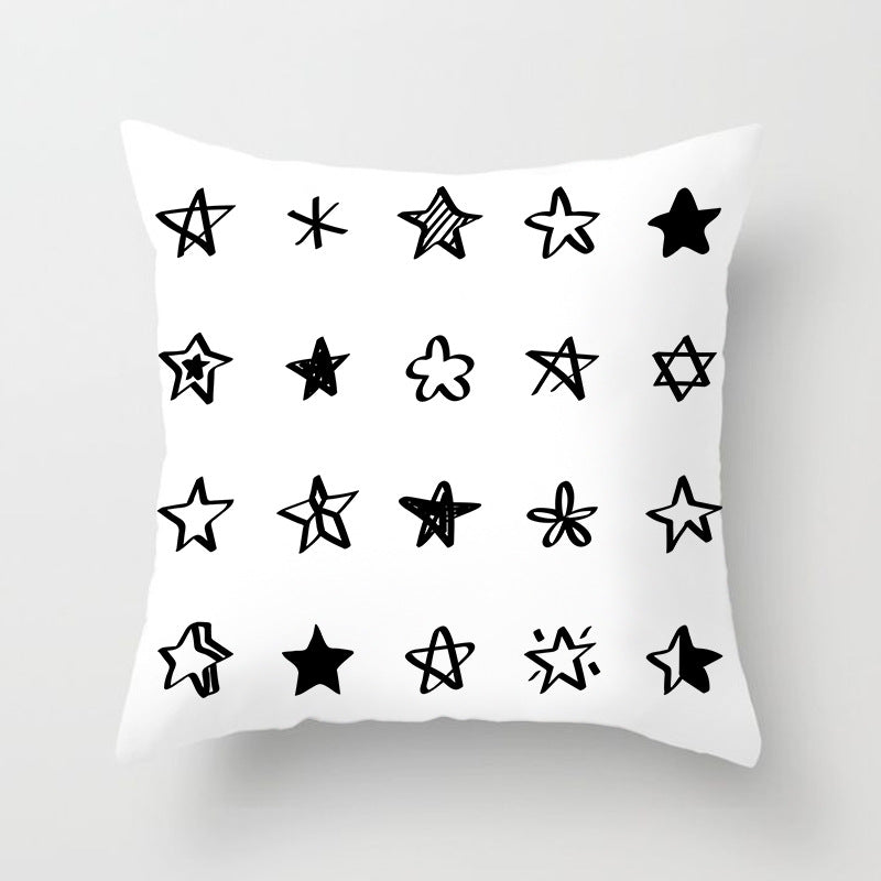 Geometric black, white, and grey jacquard knitted cushion cover by Cavira on a sofa, showcasing modern home decor.