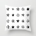 Geometric black, white, and grey jacquard knitted cushion cover by Cavira on a sofa, showcasing modern home decor.