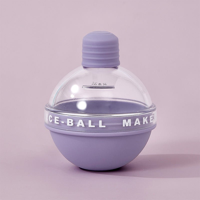 Colorful silicone ice ball mold by Cavira, creating round, slow-melt ice spheres for whiskey and cocktails in yellow, purple, blue, and pink.
