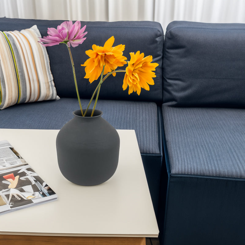 Matte metal vase by Cavira featuring a unique sculptural shape, ideal for dried flowers, pampas grass, or bouquets in white or black.