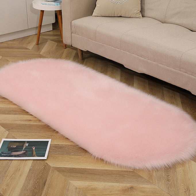 Oval acrylic plush rug by Cavira with soft imitation wool pile in various sizes and colors, suitable for bedroom or living room.