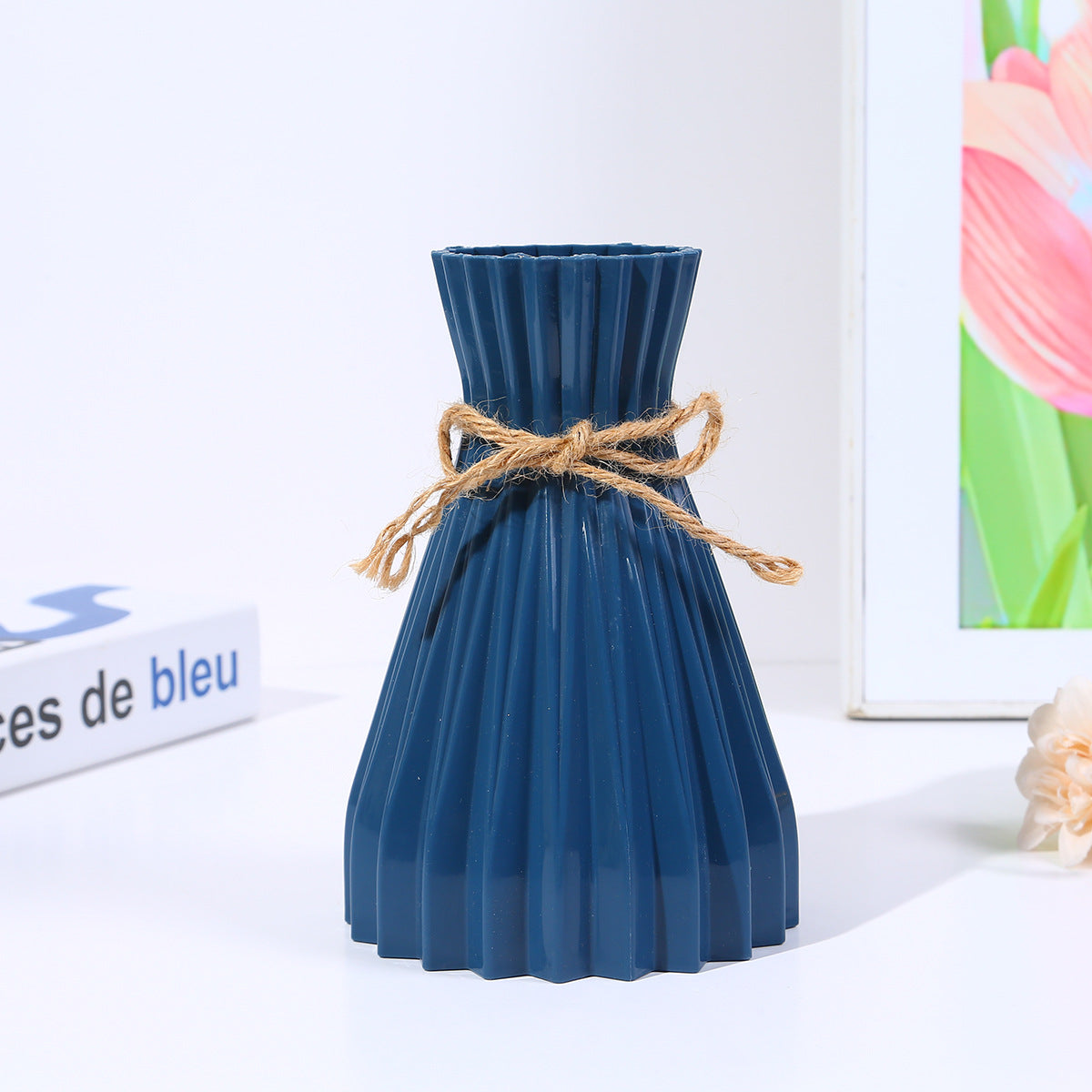 Minimalist paper vase with twine detail by Cavira, featuring a creative plastic flower arrangement for home decor and gifting.