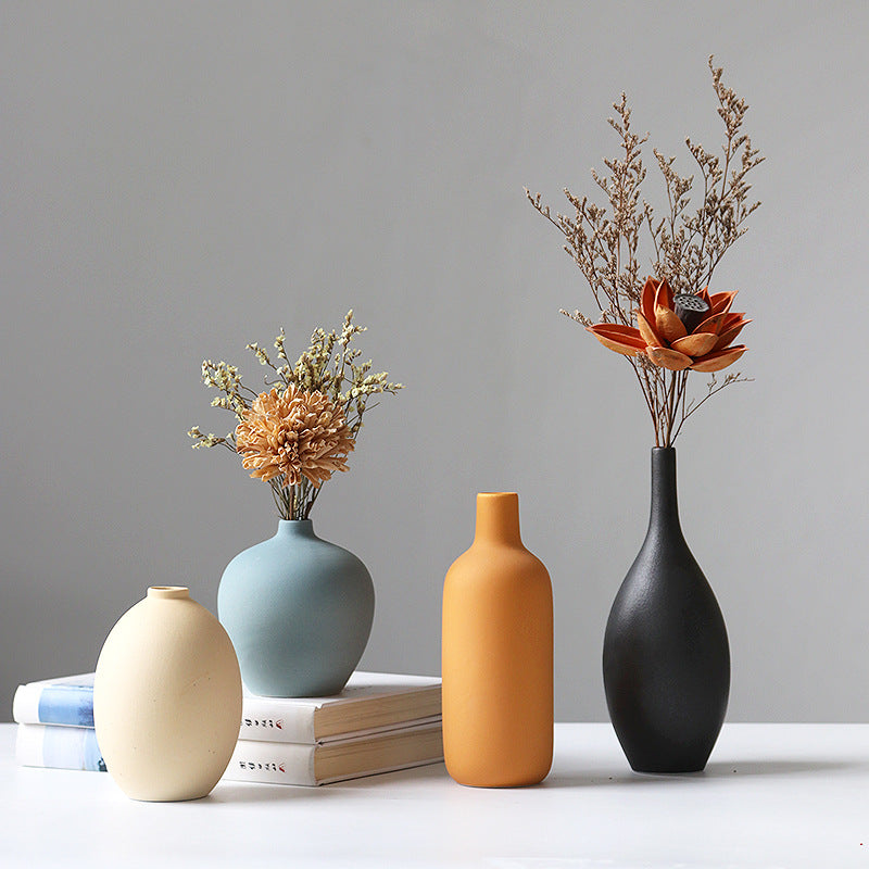 Set of four white porcelain ceramic vases by Cavira, modern minimalist design for floral arrangements and home decor.