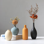 Set of four white porcelain ceramic vases by Cavira, modern minimalist design for floral arrangements and home decor.
