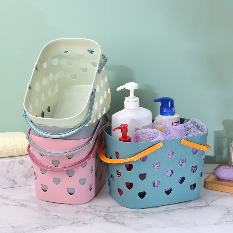 Portable Cavira hollow bath and storage basket made of PP plastic, in four colors, ideal for toiletries and laundry organization.