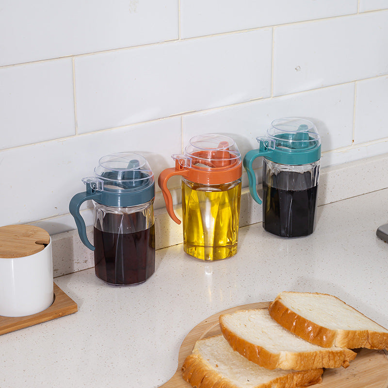 Cavira Precision Pour oil and condiment dispenser bottle with eagle-beak spout, transparent plastic, designed for drip-free pouring.