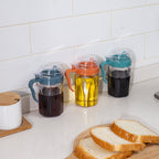Cavira Precision Pour oil and condiment dispenser bottle with eagle-beak spout, transparent plastic, designed for drip-free pouring.
