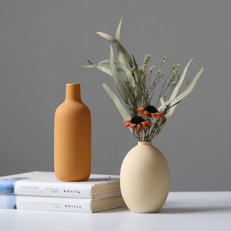 Set of four white porcelain ceramic vases by Cavira, modern minimalist flower arrangement collection for home decor and living rooms.