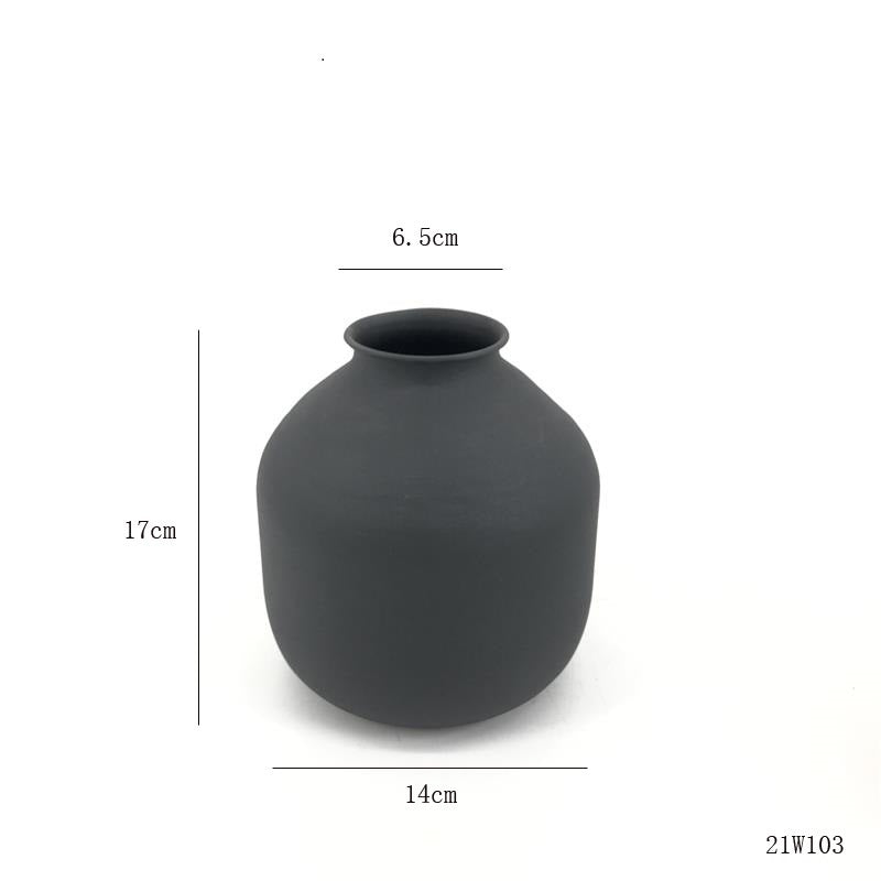 Matte metal vase by Cavira in white and black with unique sculptural shape, perfect for dried flowers, pampas grass, and home decor.