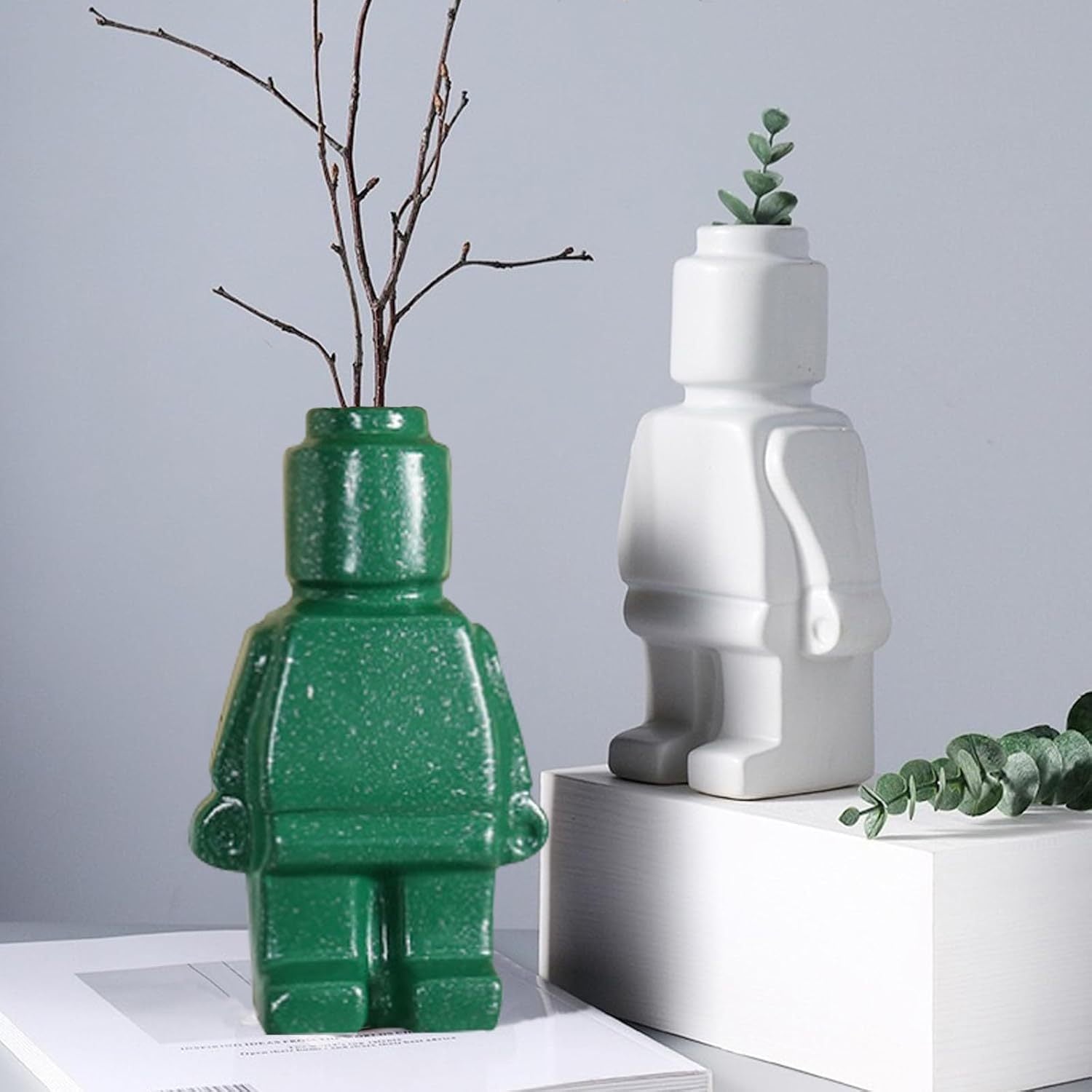 Lego resin vase by Cavira for home decor, minimalist dried flower vase on a living room shelf with dried flowers inside.