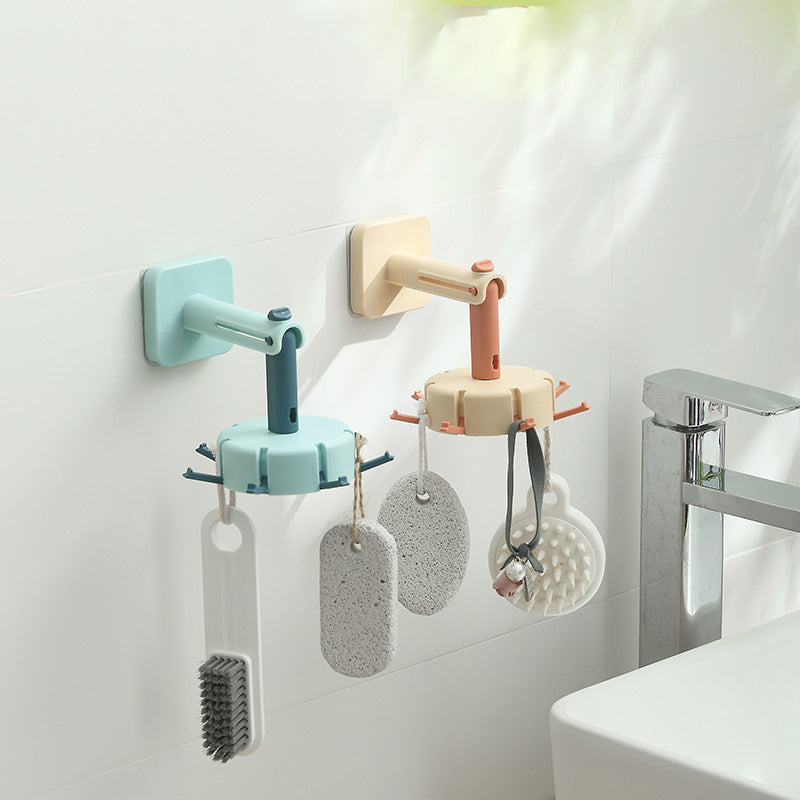 Cavira rotary multi-row adhesive wall hook in black, mounted on kitchen wall, with strong sticky surface for organizing items.