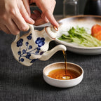 Cavira ceramic oil and vinegar dispenser bottle with auto-open lid, 150ml, in blue, white, black for kitchen condiments.
