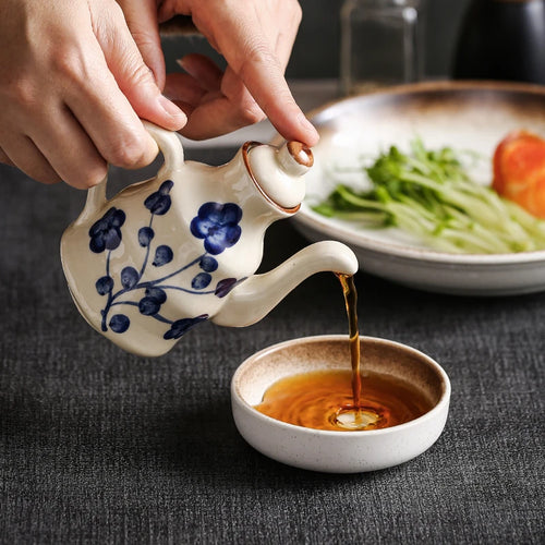 Cavira ceramic oil and vinegar dispenser bottle with auto-open lid, 150ml, in blue, white, black for kitchen condiments.