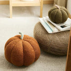 Cavira plush pumpkin pillow, soft round sofa cushion in orange with green stem, ideal for living room, bedroom, or home decor.