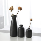 Set of three Cavira modern minimalist ceramic vases for living room decor, featuring sleek designs ideal for flowers or empty display.