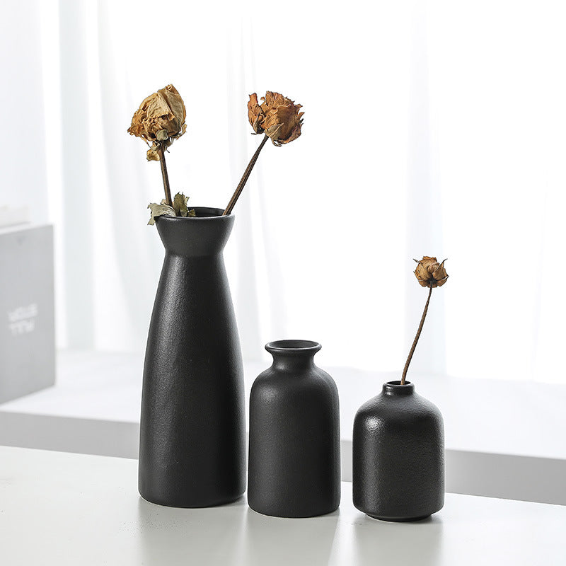 Set of three Cavira modern minimalist ceramic vases for living room decor, featuring sleek designs ideal for flowers or empty display.