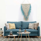 Blue bohemian hand-knotted macramé wall tapestry with cotton tassels and wooden stick for home and wedding decor.
