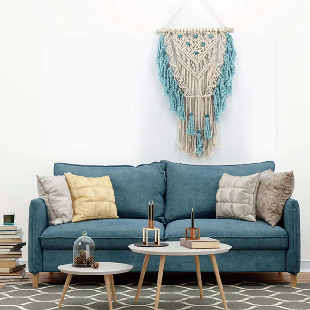 Blue bohemian hand-knotted macramé wall tapestry with cotton tassels and wooden stick for home and wedding decor.