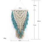Blue bohemian hand-knotted macramé wall tapestry with cotton tassels and wooden stick for home or wedding decor.