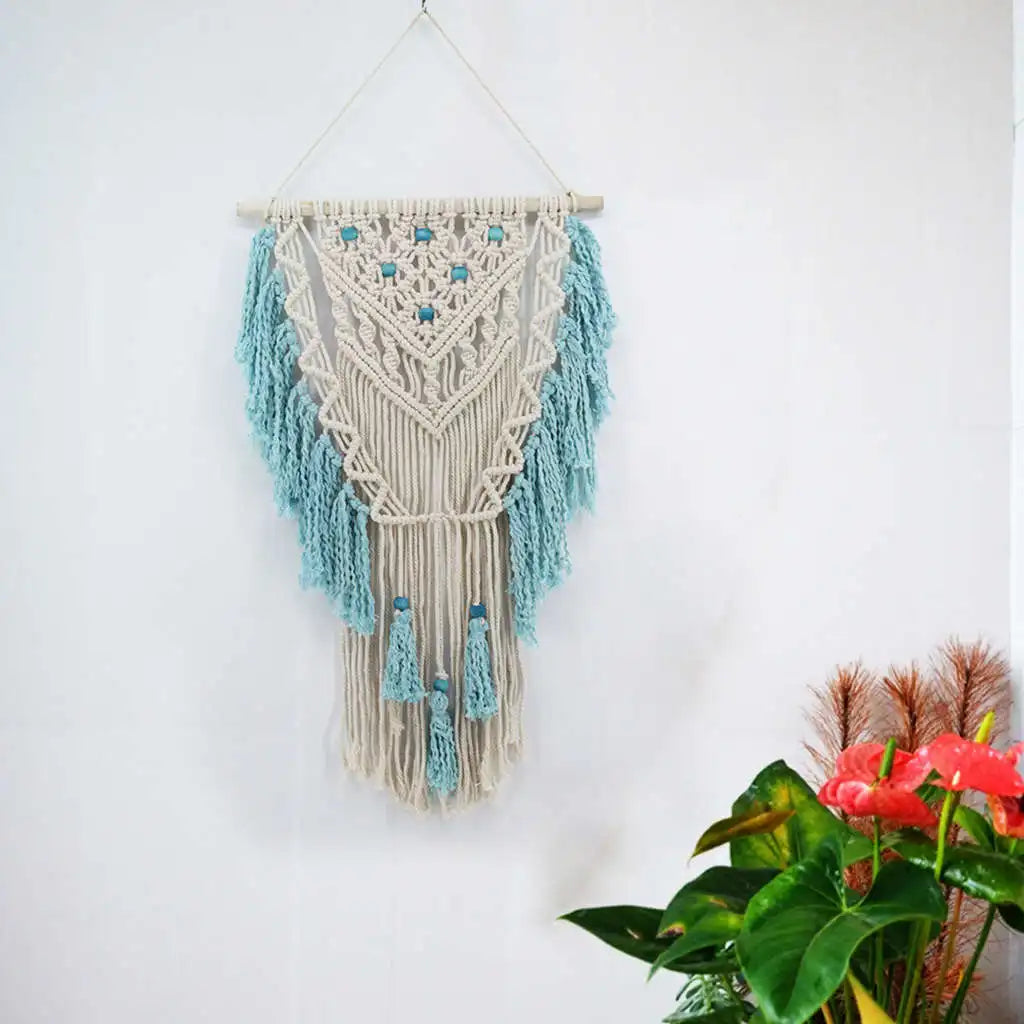 Blue bohemian hand-knotted macramé wall tapestry with cotton tassels and wooden stick for home and wedding decor.