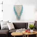 Blue bohemian hand-knotted macramé wall tapestry with cotton tassels and wooden stick for home or wedding decoration.