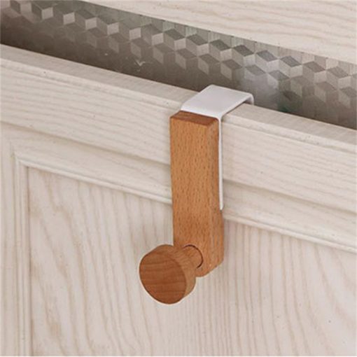 White iron and rubber wood wardrobe hook by Cavira, shown mounted on furniture for bedroom, cabinet, or wardrobe use.