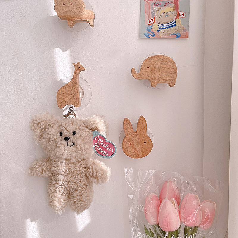 Wooden animal-shaped wall hooks for kids' rooms featuring giraffe, hippo, lion, rabbit, and elephant by Cavira.